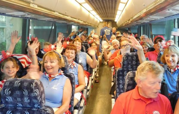 The Villages Twirlers and Drum Corps board the bus for their next destination.