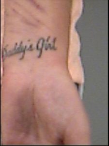 Meagan Bryson has a tattoo on her wrist that reads, "Daddy's Girls."