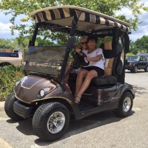 Tami Dion and Joanne Doran in the donated golf cart.