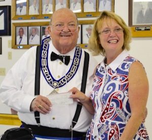 Worshipful Master Ron D’Orzio hands a $500 check to Donna Slider, manager of the Wildwood Soup Kitchen.