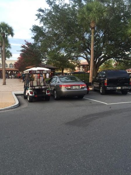 Golf cart, car sharing a space.