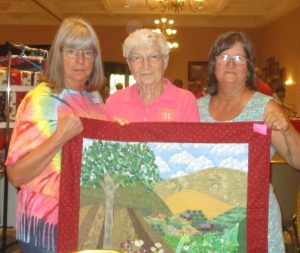 One of the founders of the first quilting chapter, the Piecemkers, Ida Hoover, center, with current co-presidents of the Piecemakers, Diane Penci and Susan Davis.