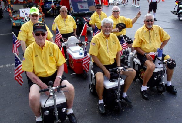 The Shriners on their motorized coolers.