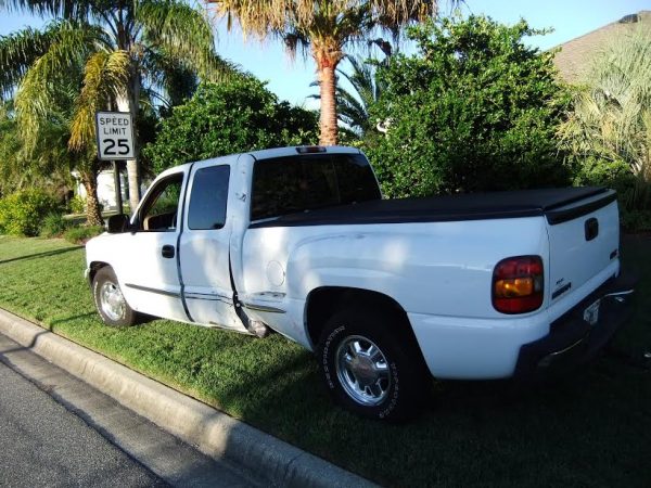 There was damage to the side of this pickup after a collision with a golf cart.