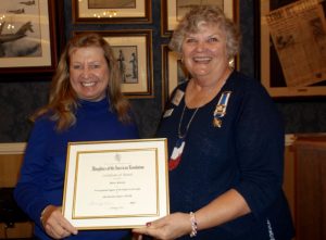 Claudia Jacques of the John Bartram Chapter of the DAR, right, presents a certificate to Meta Minton of Vilages-News.com.