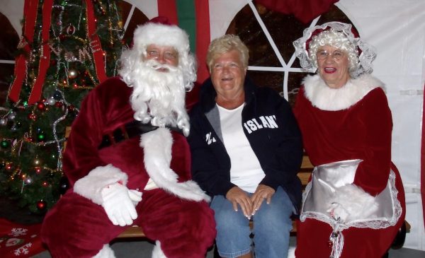 Pam Pomellow of Recreation Plantation poses with Santa and Mrs. Claus.