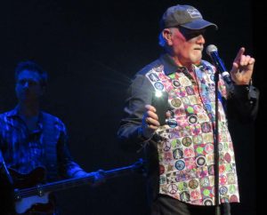 Beach Boy Mike Love shows The Sharon crowd how to wave their cellphones in the air as he sings "Surfer Girl."