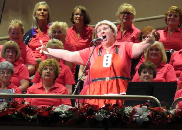 Bonnie Williams belts out Mrs. Santa Claus Monday during The Villages Pop Chorus concert.