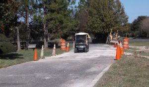 A golf cart travels on the multi-modal path between St. Charles Place and Bailey Trail.