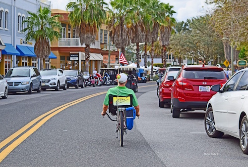 A bike rider heading into Lake Sumter Landing Town Square