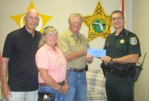 Lt. Robert Siemer accepted the donation from the Dunkirk Christmas lights show.