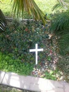 A white cross in a lawn in The Villages.