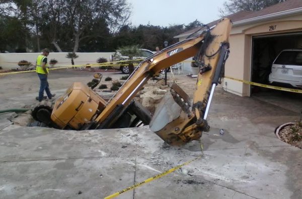 An excavator was swallowed into a hole after a water main break Saturday in the Village of Santiago.
