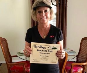 Diane Tucker shows off her hole-in-one certificate.