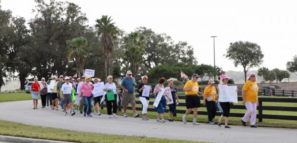 Protesters marched over the Morse Boulevard Bridge to Congressman Daniel Webster's new office in The Villages.