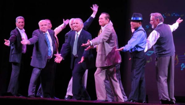 Singer David Leshay, center, was joined by a male chorus line.