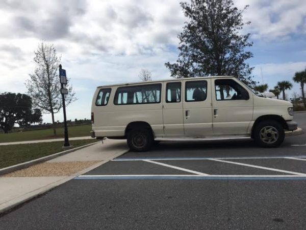 This van backed into this handicap parking space blocking the sidewalk in the Belle Glade nature preserve and he also did not have a handicap tag