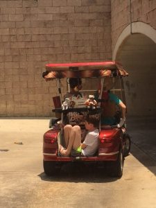 A Villager shot this photo of a grandchild riding in the storage space on the rear of a golf cart.