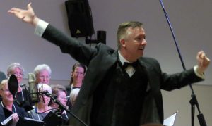 Conductor John T Rowe Jr leads The Village Voices in their 20th Anniversary concert.