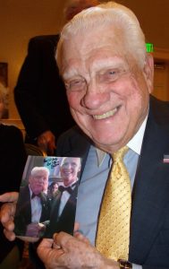 John Long shows off a photo of him and Gov. Rick Scott taken at the Florida Ball earlier this year.
