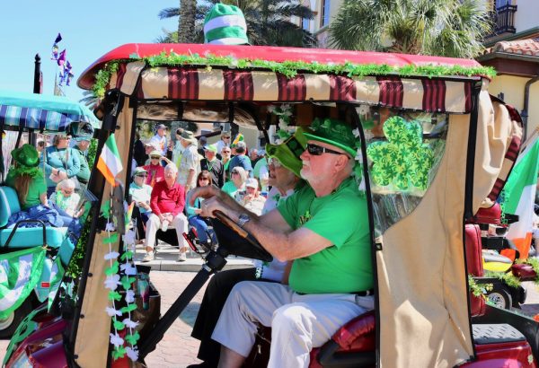 John Nelson pilots his shamrock bedecked cart around the parade route.