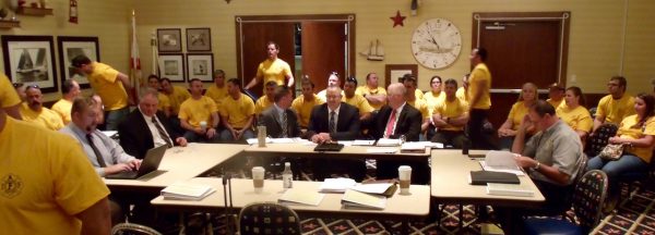 Many at Tuesday's meeting wore gold T-shirts of the firefighters union.