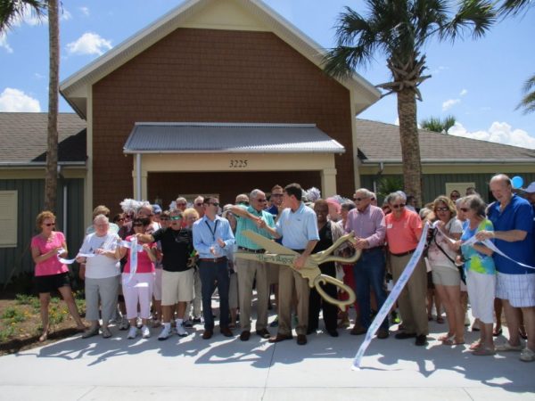 Mayor Ed Wolf and Gary Lester of The Villages shake hands after cutting the ribbon.