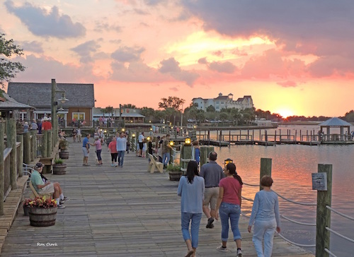 Folks enjoying the sunset at Lake Sumter Landing boardwalk