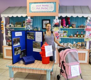 Jean Olivier-White, owner of Just Dandy Pet Parlor shows the display and raffle prizes.