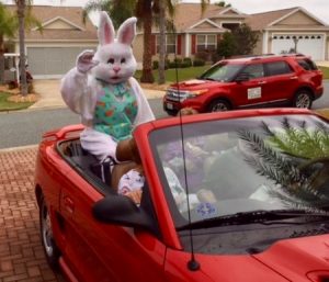 MaryKay Childress rides in a convertible as the Easter Bunny.