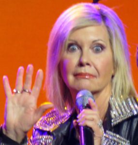 Olivia Newton-John shares a funny moment with the audience.