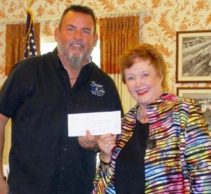 Pastor Dave Houck receiving check from Fran Norton.