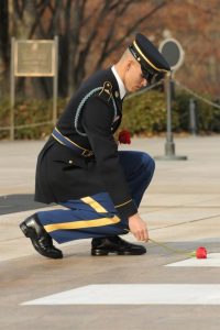 Staff Sgt. Shane Vincent places a rose at the Tomb of the Unknown Soldier.