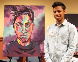 Steven Pinto alongside his self-portrait.