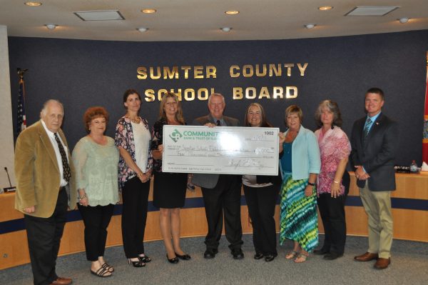 Sumter County school officials accept a $5,000 check from Community Bank & Trust of Florida.