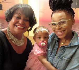 Toni Booker, left, poses with the Dorels biggest fans her great-granddaughter Melina 10-months old and Booker's granddaughter Tristan.