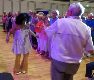 Villager Vic Dunphy back to cameara does a funky dance with singer La La Brooks who came out into the audience.