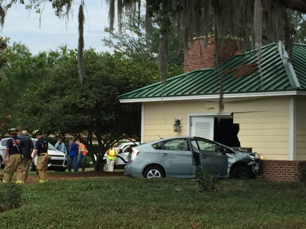 A distracted driver crashed her vehicle into a building in the center of a roundabout.