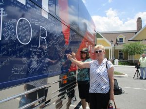 Dr. Darlene Druzenvich and Ann Peters signing the tour bus.