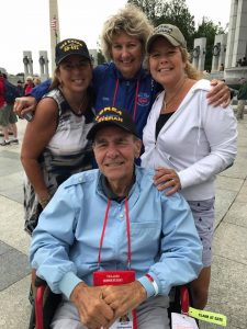 Ed Ferreira is greeted by his daughters at the National World War II Memorial. Top center is his Guardian, Joyce Cover.