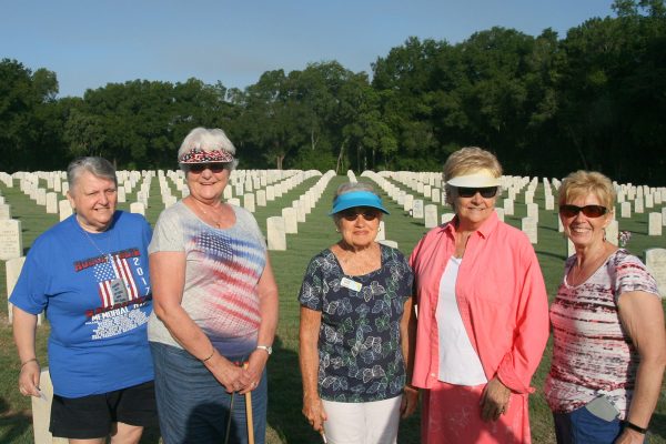 Members of The Villages Puc Puggy Chapter, NSDAR helped place flags at graves at Florida National Cemetery.