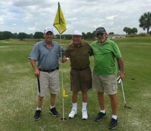 Sandy Neill, center, recently got a hole-in-one.