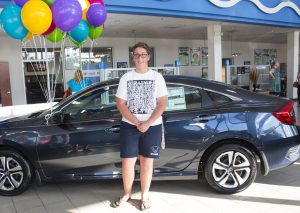 Tyler standing in front of his brand new 2017 Honda Civic Coupe LX