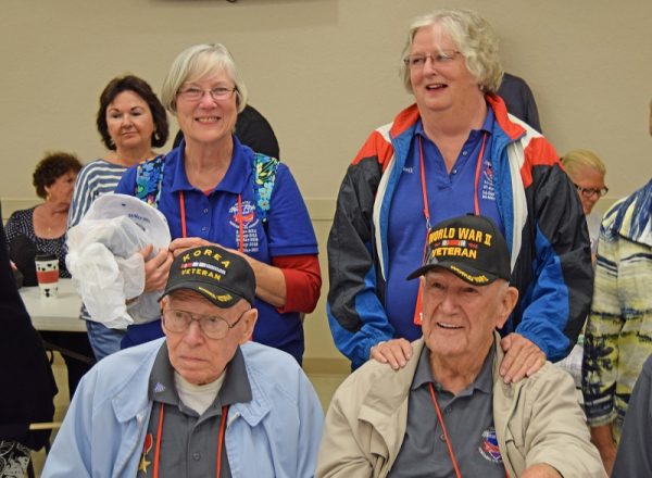 Veteran Ed Murray, with Guardian Betsy Abshire standing behind, and Veteran Charles Prince with Guardian Marilyn Gagen standing behind him, from left..