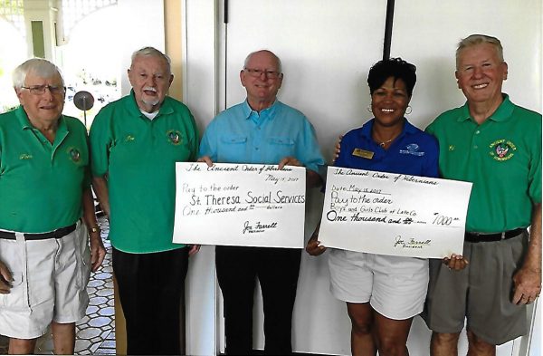 Tom Wiseman, AOH Charity Committee; Joe Farrell, president of the AOH; Jimmy Johnson of St. Theresa's Social Services; Tonya Porter, director of the Lady Lake Boys and Girls Club; Ed Flanagan, chairman of the AOH Charity Committee, from left.
