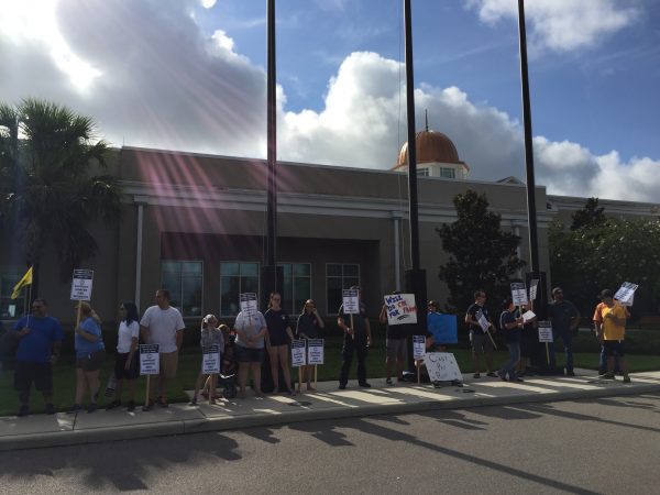 Protestors gathered in front of the Sumter County Service Center Friday morning to fight for fair pay and benefits.