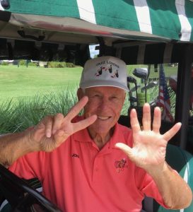 John Blum flashes a seven in honor of his seventh hole-in-one.