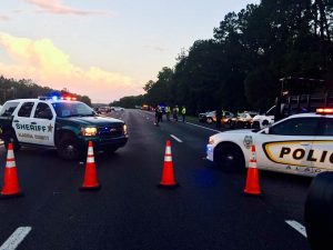 Law enforcement vehicles block Interstate 75 during the investigation of an accident that claimed the life of a FHP trooper.