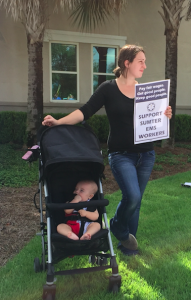 Autumn Carpenter with her baby protesting for her husband who was working Friday morning.