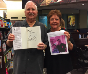 Villagers Ed and Dorie Rendemonti show off their signed copy of Bolling's new book as well as a photo of Dorie and Bolling. 